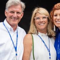 Randy Damstra smiling with two guests at the Jamie Hosford Football Center dedication.